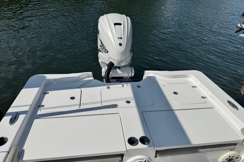 Slide: The Image of 2021 Sportsman Masters 267 Bay Boat with powerful V8 engine on calm water. - 23