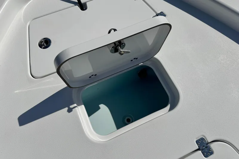 Slide: The Image of 2021 Sportsman Masters 267 Bay Boat storage compartment with open hatch and latch detail. - 35