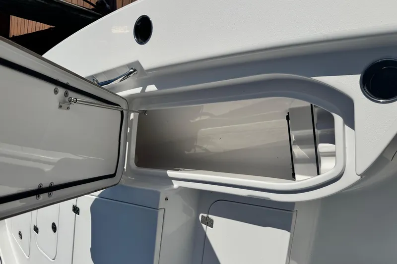 Slide: The Image of 2021 Sportsman Masters 267 Bay Boat open storage compartment on deck. - 39