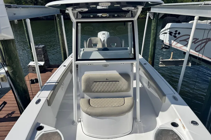 Slide: The Image of 2021 Sportsman Masters 267 Bay Boat docked, featuring spacious seating and sleek design. - 40
