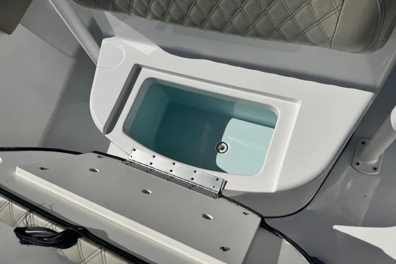 Slide: The Image of 2021 Sportsman Masters 267 Bay Boat interior storage compartment with cushioned seating. - 41