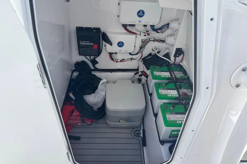 Slide: The Image of 2021 Sportsman Masters 267 Bay Boat battery compartment with wiring and equipment. - 43