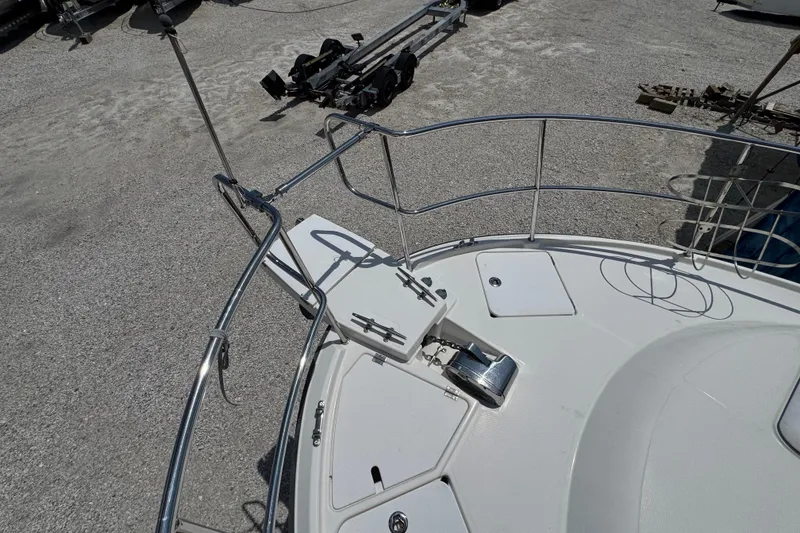 Slide: The Image of 2019 Ranger Tugs R-29 CB boat deck with anchor and railing in a gravel lot. - 48