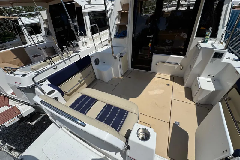 Slide: The Image of 2019 Ranger Tugs R-29 CB boat cockpit with seating and storage compartments. - 7