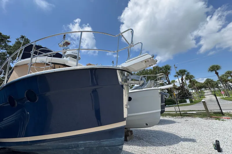Slide: The Image of 2019 Ranger Tugs R-29 CB boat on display under a clear blue sky. - 3
