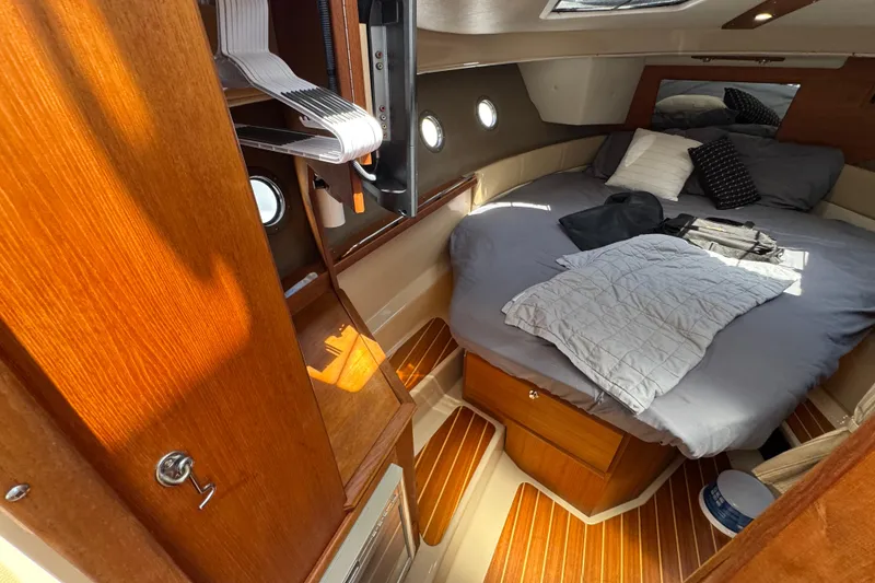 Slide: The Image of Cozy cabin interior of 2019 Ranger Tugs R-29 CB with wooden accents and comfortable bedding. - 30