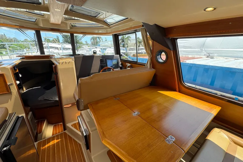 Slide: The Image of Interior of 2019 Ranger Tugs R-29 CB, featuring wood finishes and ample natural light. - 24