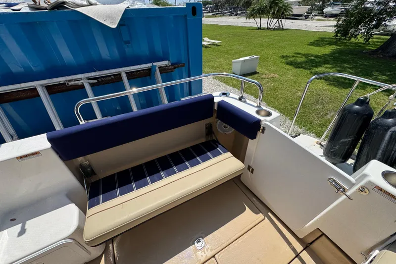 Slide: The Image of 2019 Ranger Tugs R-29 CB boat seating area with blue and beige cushions. - 11