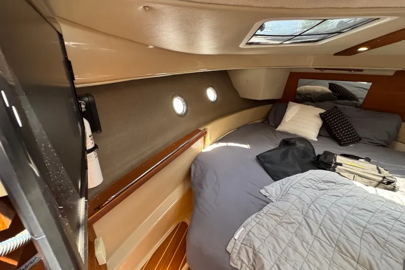 Slide: The Image of 2019 Ranger Tugs R-29 CB cabin interior with bed, portholes, and skylight. - 33