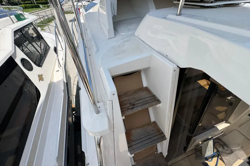 Slide: The Image of 2019 Ranger Tugs R-29 CB boat with wooden steps and sleek white exterior. - 41