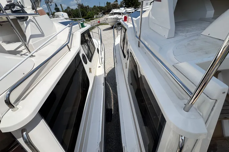 Slide: The Image of 2019 Ranger Tugs R-29 CB boats docked side by side, showcasing sleek design and chrome railings. - 46