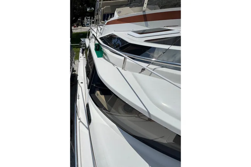 Slide: The Image of 2019 Ranger Tugs R-29 CB boat, sleek white exterior, docked in a marina. - 50