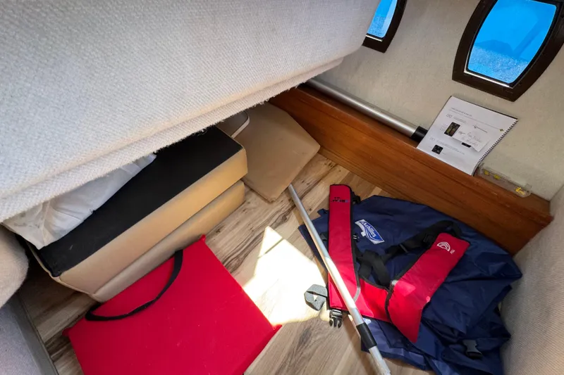 Slide: The Image of Interior of 2019 Ranger Tugs R-29 CB with life jackets and boating equipment. - 23