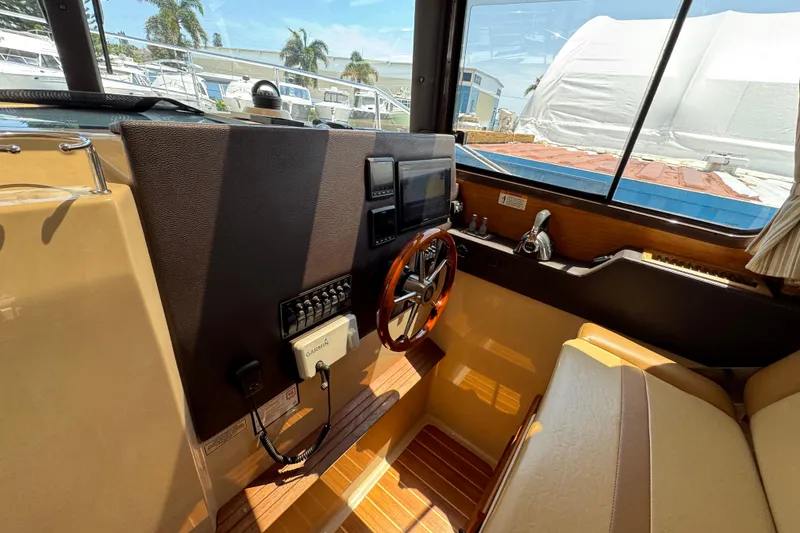 Slide: The Image of Interior helm of 2019 Ranger Tugs R-29 CB with steering wheel and navigation equipment. - 26