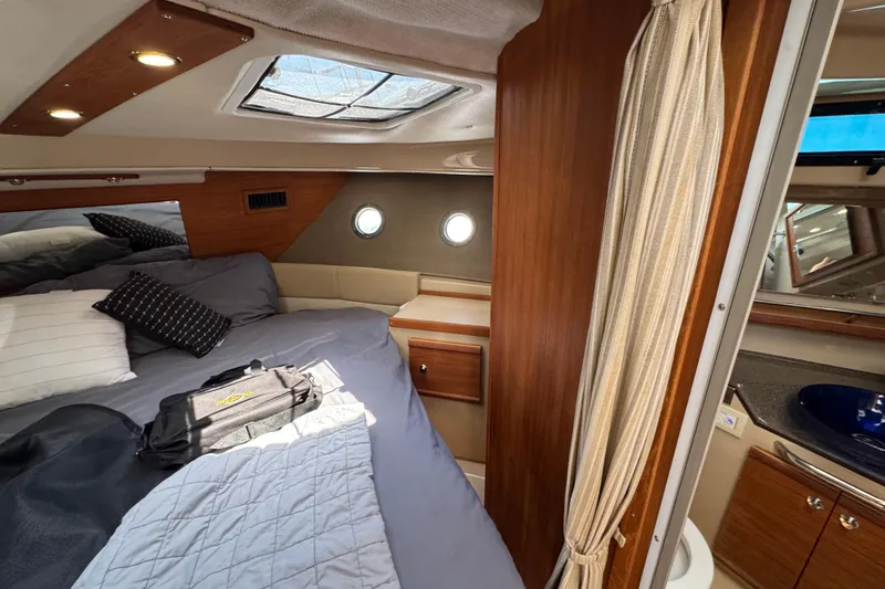 Slide: The Image of Cozy cabin interior of 2019 Ranger Tugs R-29 CB with bed and portholes. - 32