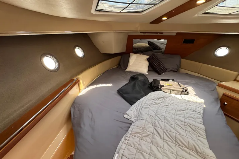 Slide: The Image of Cozy cabin interior of 2019 Ranger Tugs R-29 CB with bed and portholes. - 31