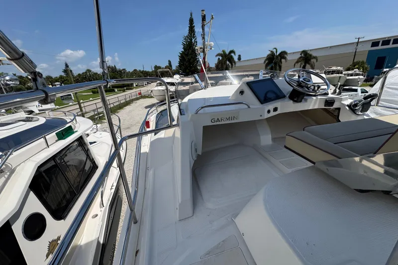 Slide: The Image of 2019 Ranger Tugs R-29 CB boat cockpit with Garmin navigation system, docked outdoors. - 42