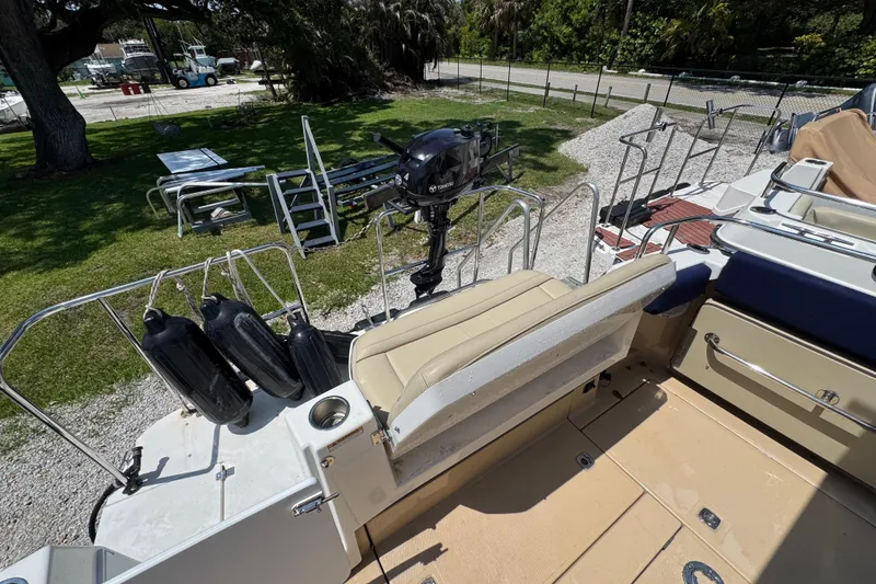 Slide: The Image of 2019 Ranger Tugs R-29 CB boat deck with seating and motor, docked outdoors. - 14