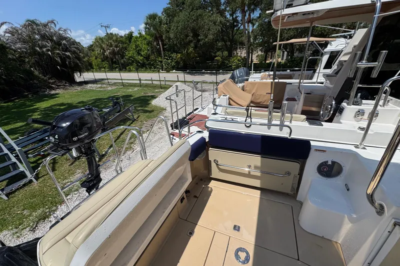 Slide: The Image of 2019 Ranger Tugs R-29 CB boat deck with seating and outboard motor. - 16