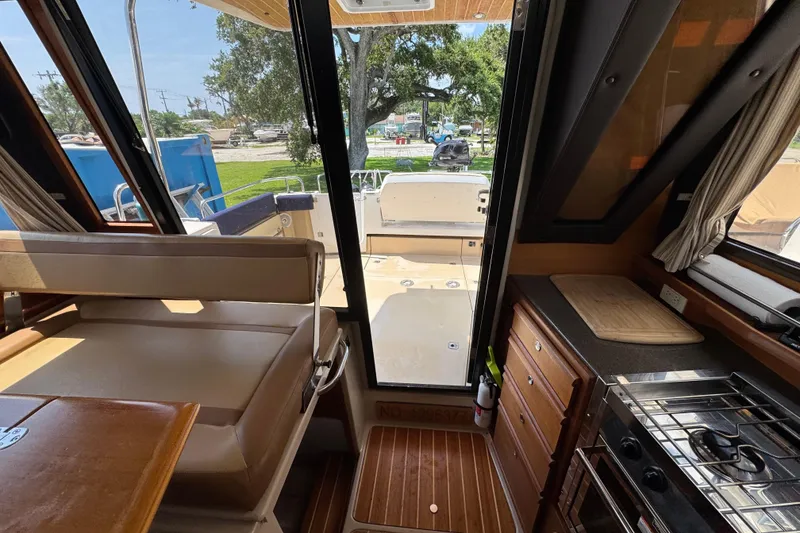 Slide: The Image of Interior view of 2019 Ranger Tugs R-29 CB, featuring seating and kitchen area. - 39