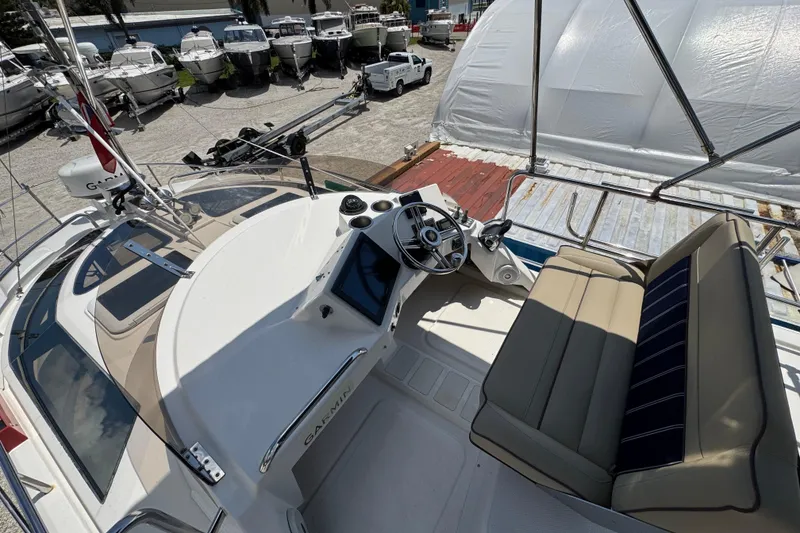 Slide: The Image of 2019 Ranger Tugs R-29 CB boat helm with seating, docked among other boats. - 43