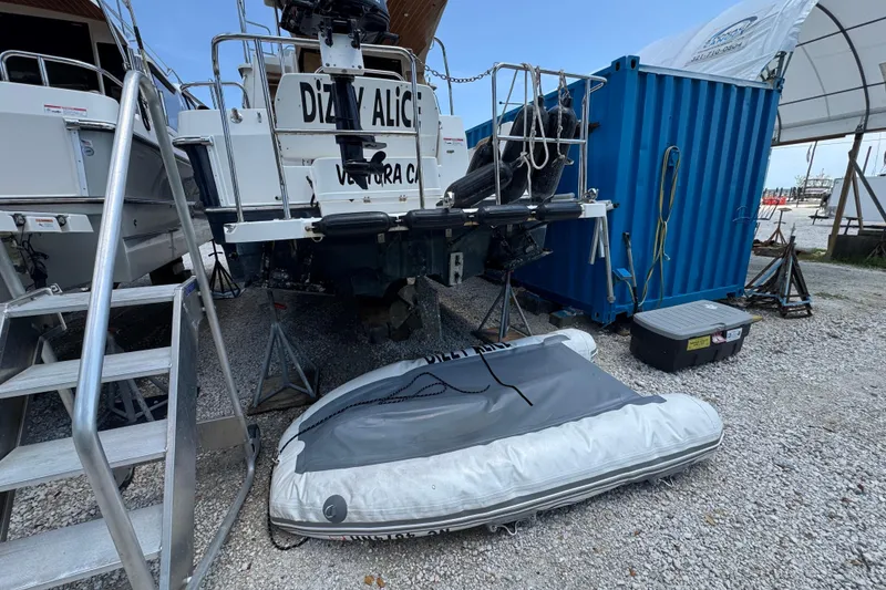 Slide: The Image of 2019 Ranger Tugs R-29 CB boat on land with inflatable dinghy nearby. - 52