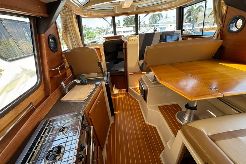 Slide: The Image of 2019 Ranger Tugs R-29 CB interior with wood finishes and modern amenities. - 20