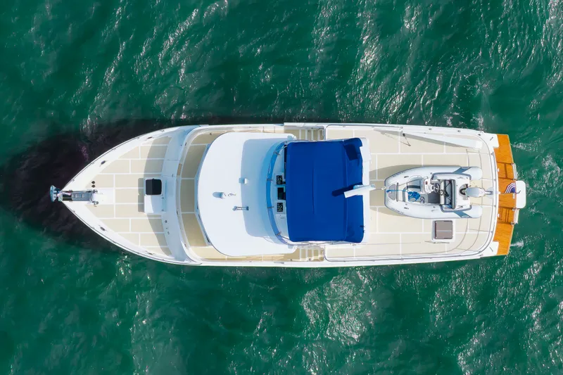 Slide: The Image of Aerial view of a DeFever Euro 52 yacht on the water with a blue sunshade. - 13