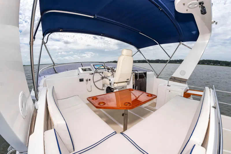 Slide: The Image of The image shows the helm of a 2016 DeFever Euro 52 with a blue canopy. - 17