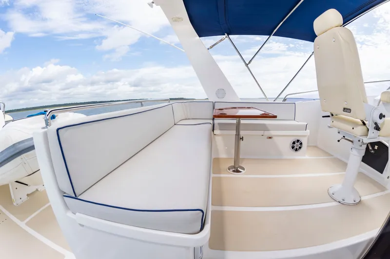 Slide: The Image of The image shows the deck of a 2016 DeFever Euro 52 with seating area and table. - 18