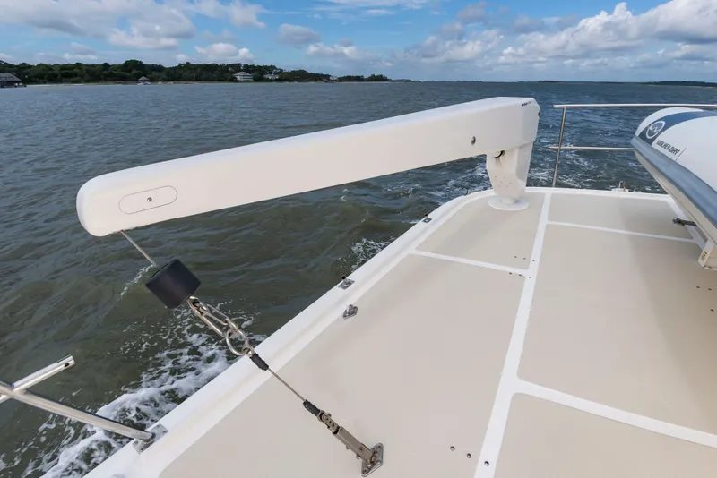 Slide: The Image of 2016 DeFever Euro 52 on calm water with crane and dinghy. - 27