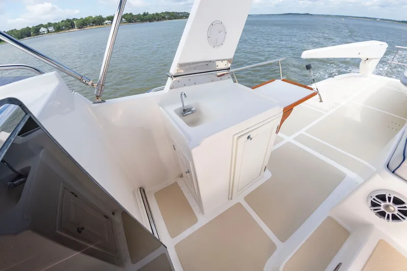 Slide: The Image of The image shows the deck of a 2016 DeFever Euro 52 with a sink and storage. - 28
