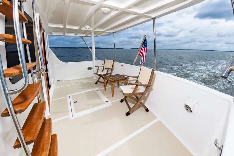 Slide: The Image of The deck of a 2016 DeFever Euro 52 with chairs and a table. - 35