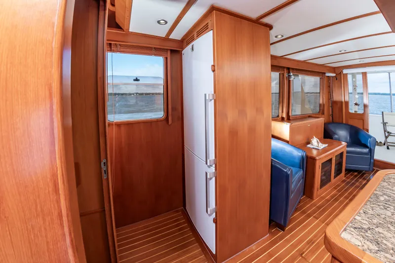Slide: The Image of Interior of the 2016 DeFever Euro 52 with wood finish and blue leather chairs. - 44