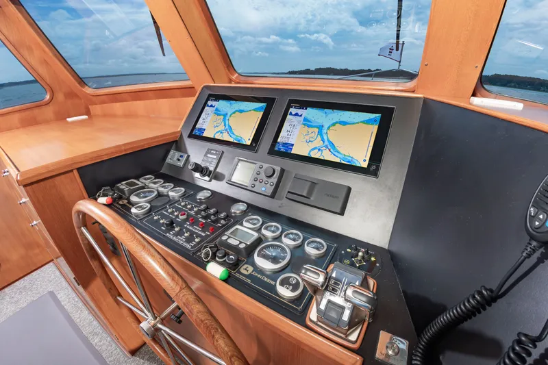 Slide: The Image of Helm of the DeFever Euro 52 with modern navigation systems and wood finish. - 49