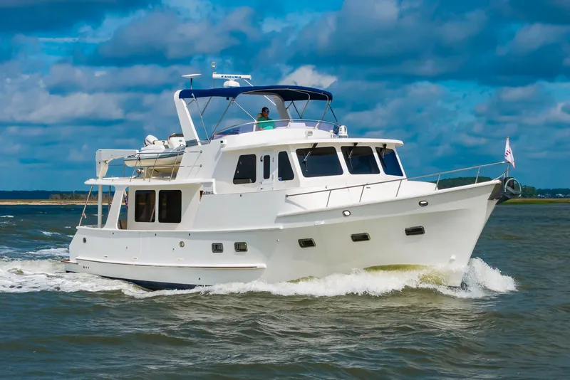 Slide: The Image of 2016 DeFever Euro 52 cruising on water under a blue sky. - 5
