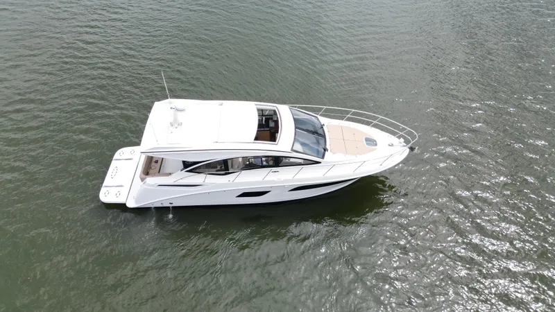 Slide: The Image of 2017 Sea Ray Sundancer 400 yacht on open water, aerial view. - 10