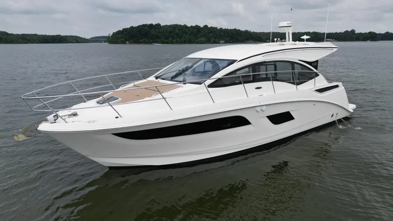 Slide: The Image of 2017 Sea Ray Sundancer 400 yacht on calm water, showcasing sleek design and modern features. - 3