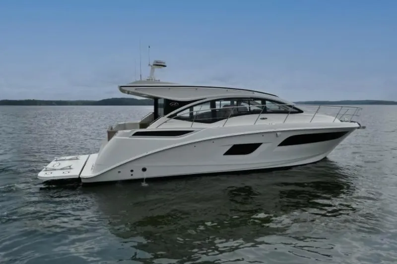 Slide: The Image of 2017 Sea Ray Sundancer 400 yacht on calm water under a clear sky. - 6