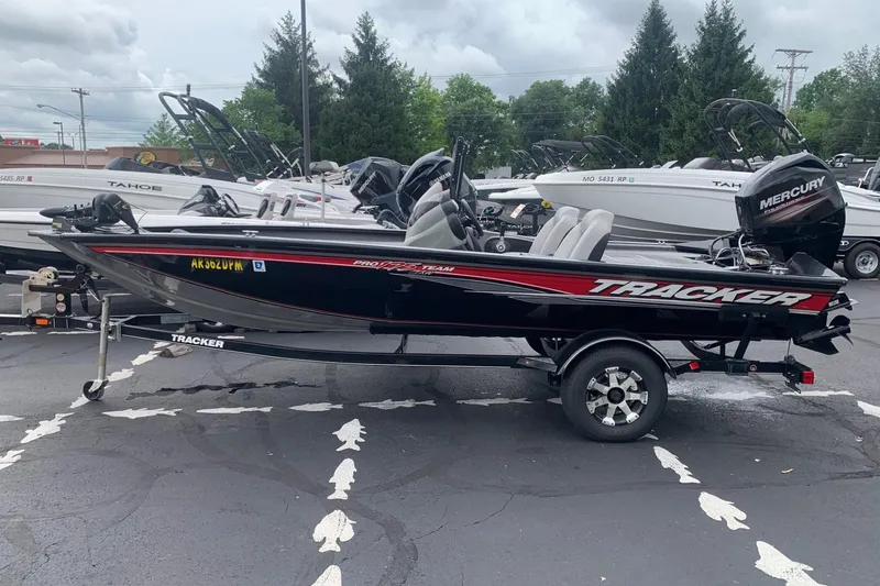 The Image of 2016 Tracker Pro Team 175 TXW boat with Mercury engine on trailer, parked outdoors. - 1