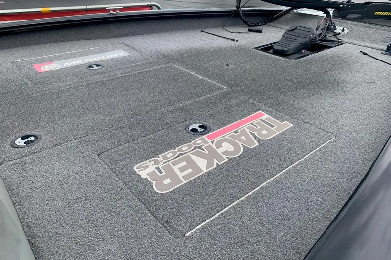 Slide: The Image of 2016 Tracker Pro Team 175 TXW boat deck with Mercury branding and storage compartments. - 5