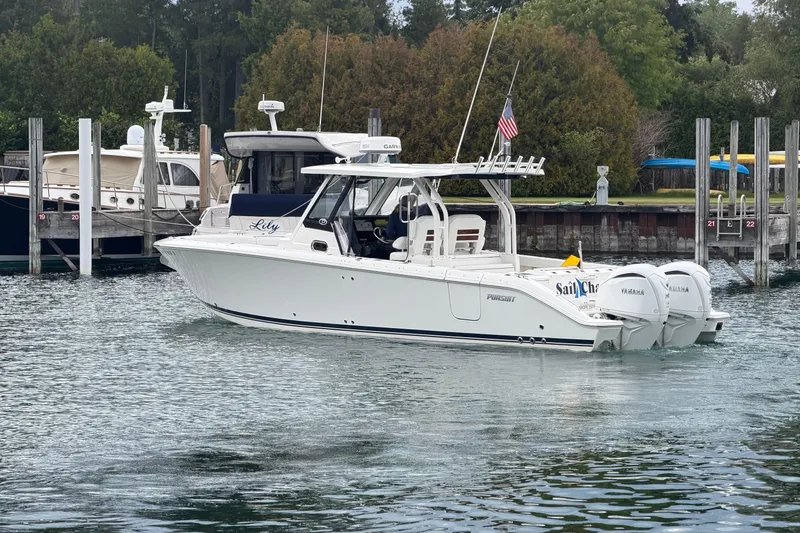 The Image of 2024 Pursuit S 328 Sport boat docked in a marina, featuring twin Yamaha engines. - 0