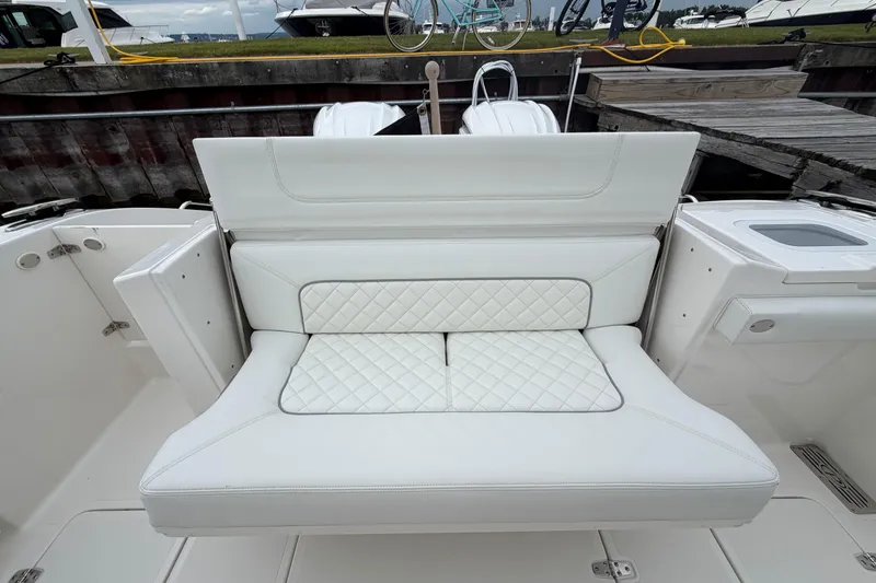 Slide: The Image of 2024 Pursuit S 328 Sport boat with luxurious white quilted seating. - 17