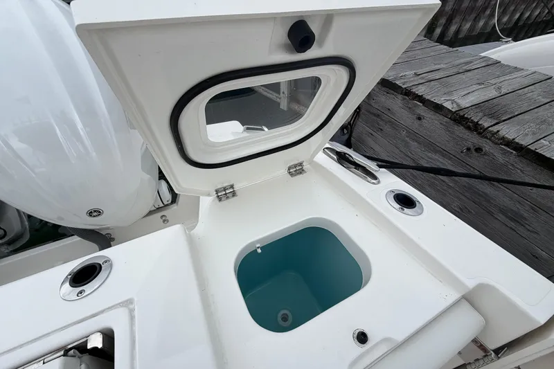 Slide: The Image of Open hatch on 2024 Pursuit S 328 Sport boat, revealing storage compartment. - 19