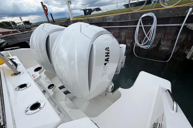 Slide: The Image of 2024 Pursuit S 328 Sport boat with dual Yamaha outboard engines docked by the water. - 20