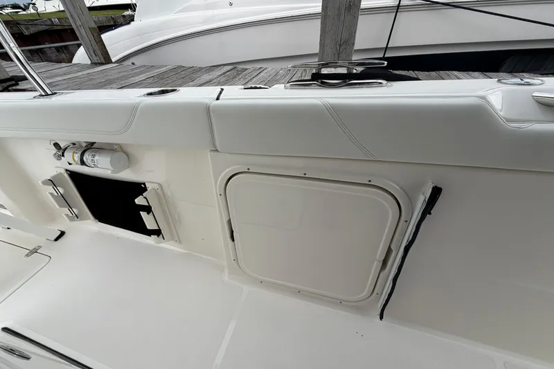 Slide: The Image of 2024 Pursuit S 328 Sport boat deck with storage compartments and safety equipment. - 22
