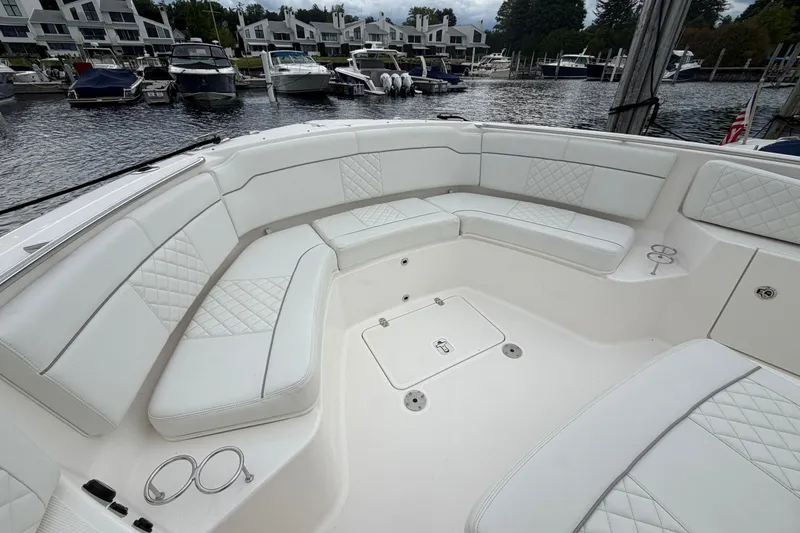 Slide: The Image of Luxurious seating area on 2024 Pursuit S 328 Sport boat at marina. - 23