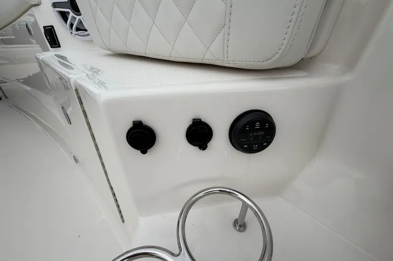 Slide: The Image of 2024 Pursuit S 328 Sport boat interior with audio controls and cup holder. - 25