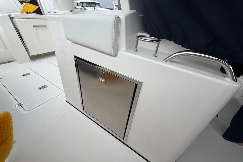 Slide: The Image of 2024 Pursuit S 328 Sport boat interior with stainless steel storage compartment. - 29