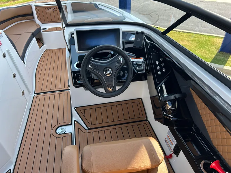 Slide: The Image of The image shows the cockpit of a 2026 Yamaha 252SD boat with a modern steering wheel and display. - 15